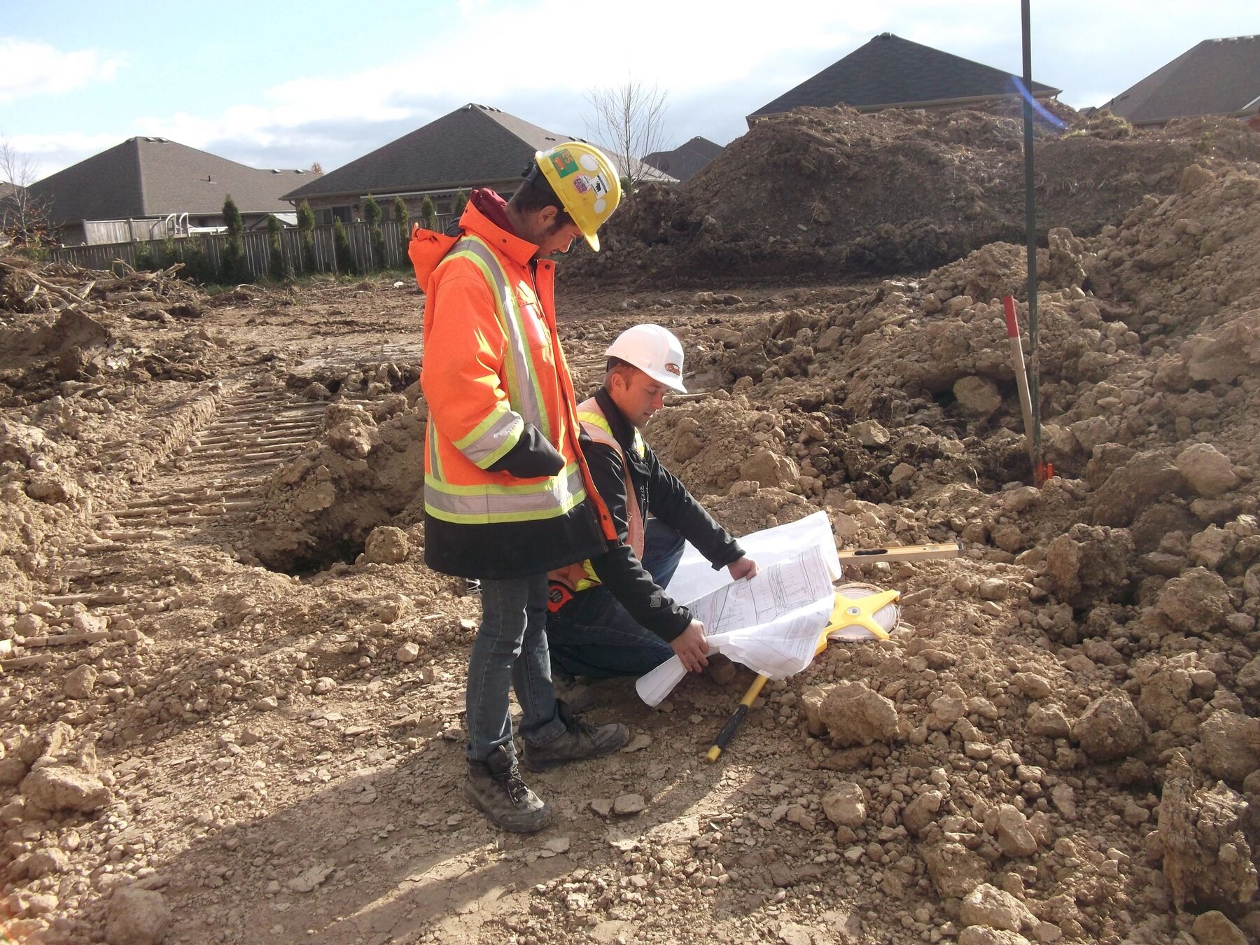 Clarke Construction team reviewing plans at a worksite