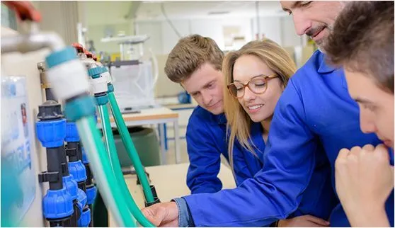 Drain King technicians reviewing a valve assembly during training