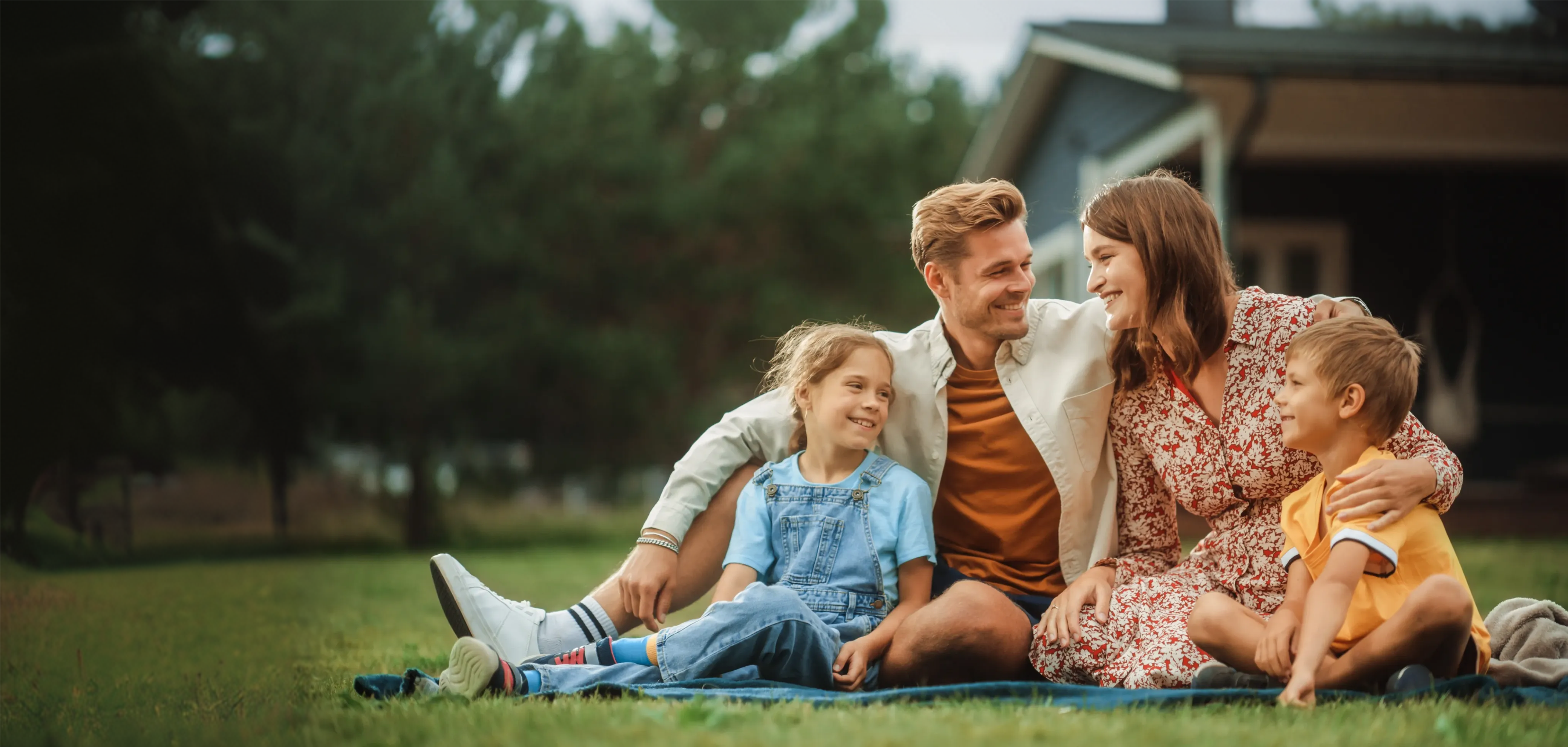 Happy Alberta family outside their home