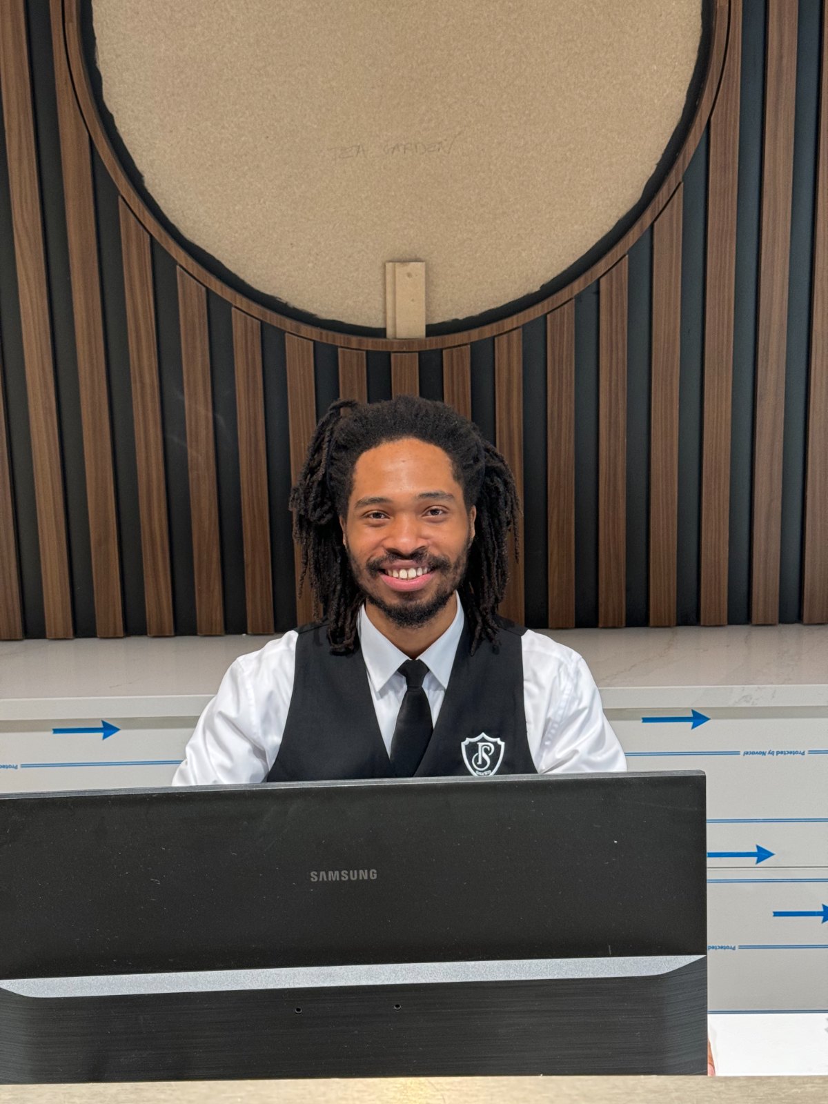 A Probe Security concierge greeting residents with a smile at the front desk