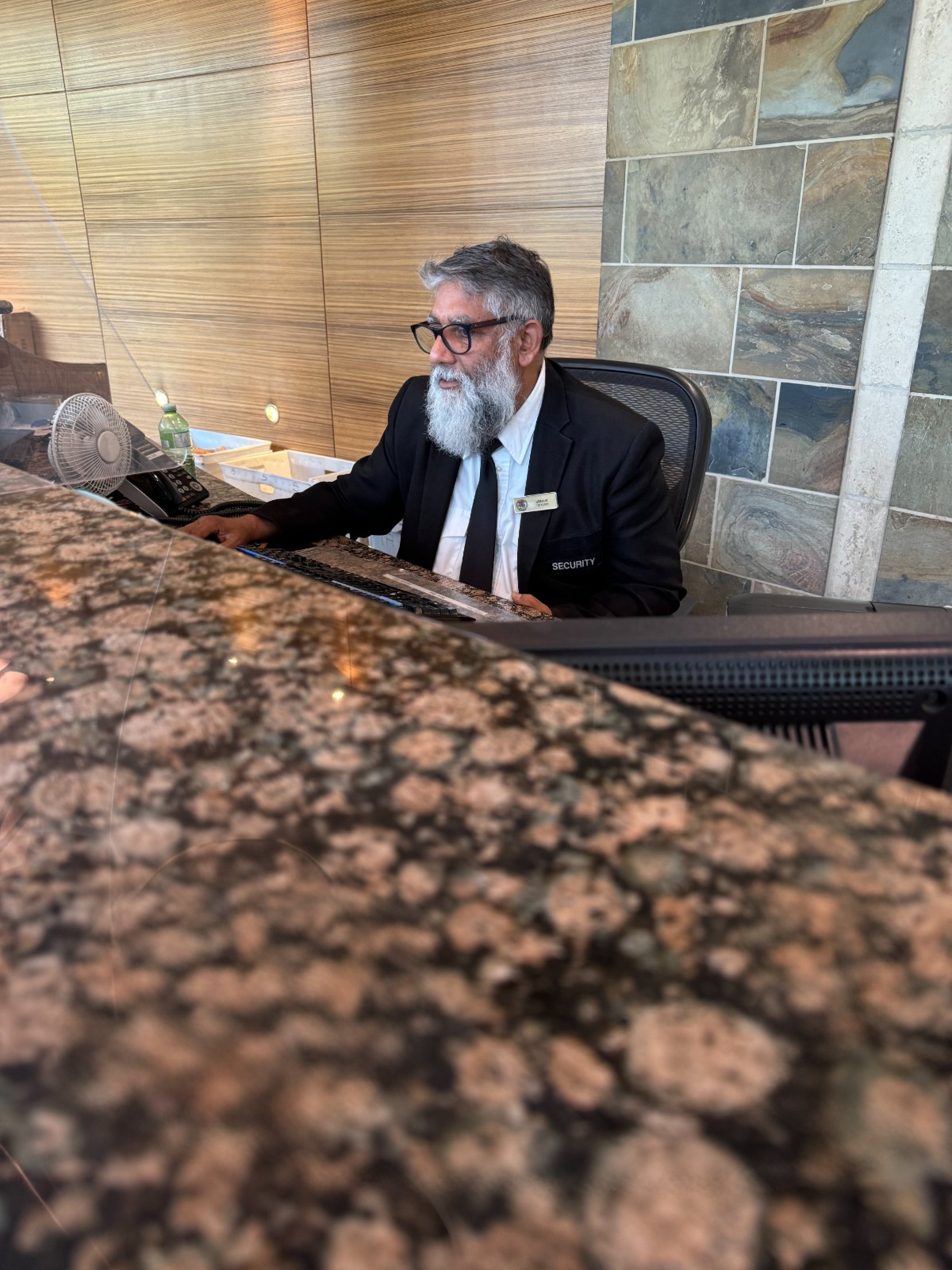 A Probe Security officer on duty at a condominium concierge desk