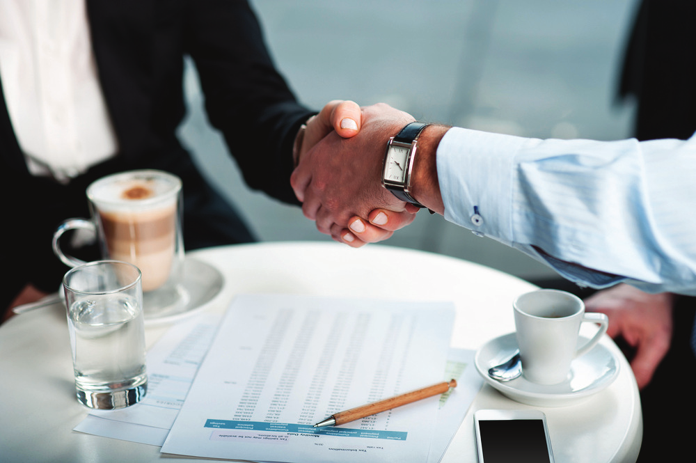 A Probe representative warmly greeting a resident with a handshake