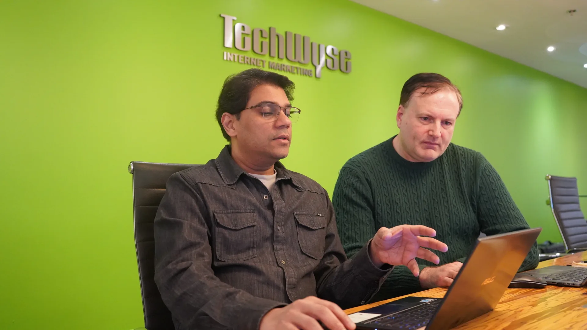 Two TechWyse strategists reviewing work together